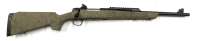Tan camouflage bolt-action rifle shown in profile against a white background, with a long barrel and rear pad visible.